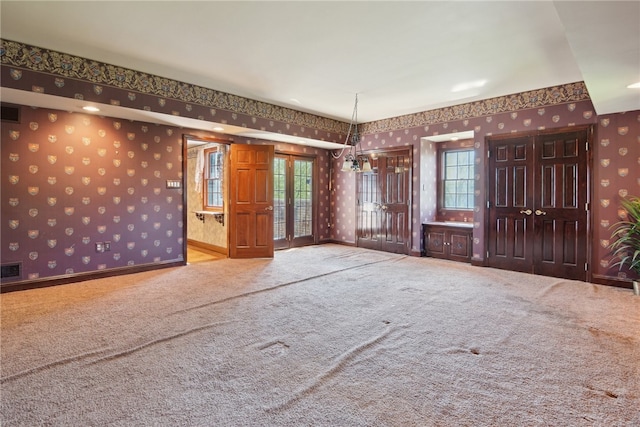 107 Treetop Ln, Peters Twp, PA 15317 - unfurnished room featuring carpet floors, baseboards, visible vents, and wallpapered walls