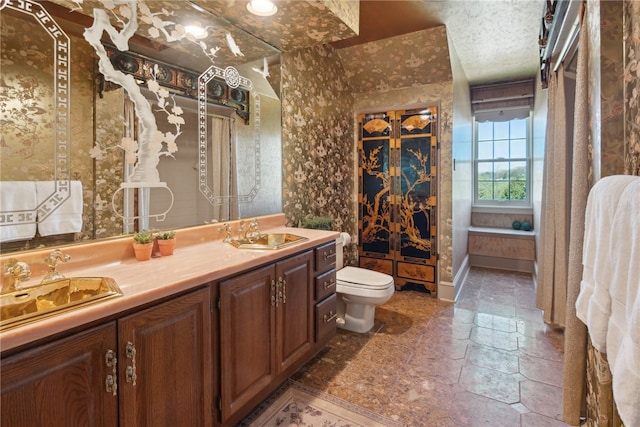 107 Treetop Ln, Peters Twp, PA 15317 - bathroom featuring vanity, toilet, and stone tile floors