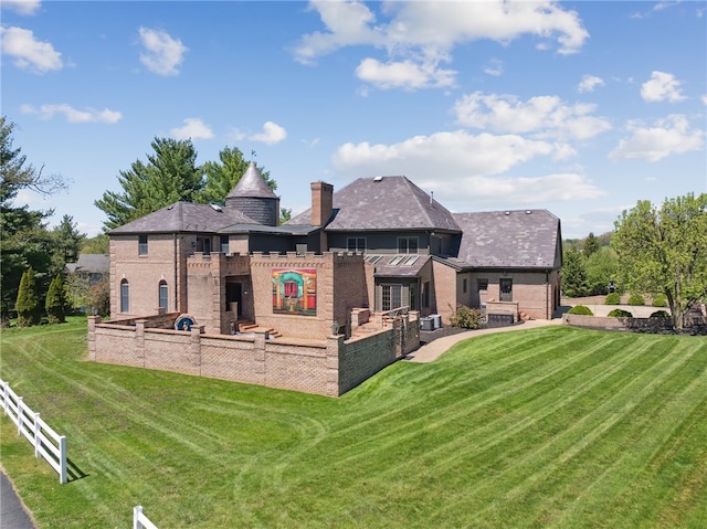 107 Treetop Ln, Peters Twp, PA 15317 - rear view of house featuring a yard, brick siding, and a chimney