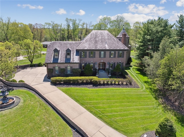 107 Treetop Ln, Peters Twp, PA 15317 - view of front of house featuring a front lawn, brick siding, and a high end roof