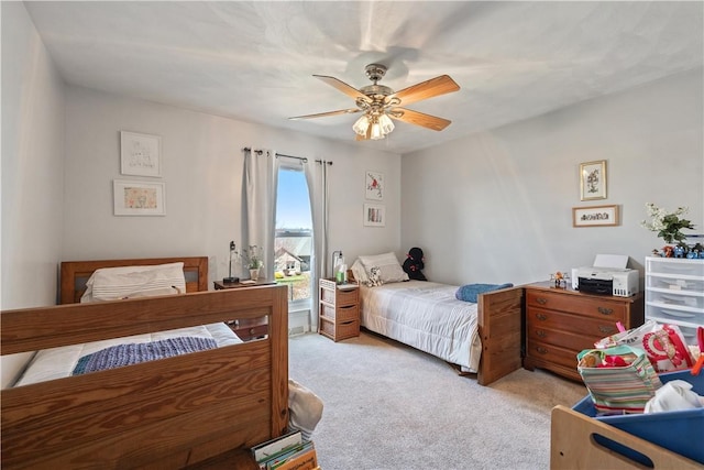 bedroom featuring a ceiling fan and light carpet