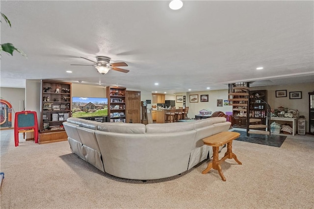 living room featuring recessed lighting, a ceiling fan, and light colored carpet