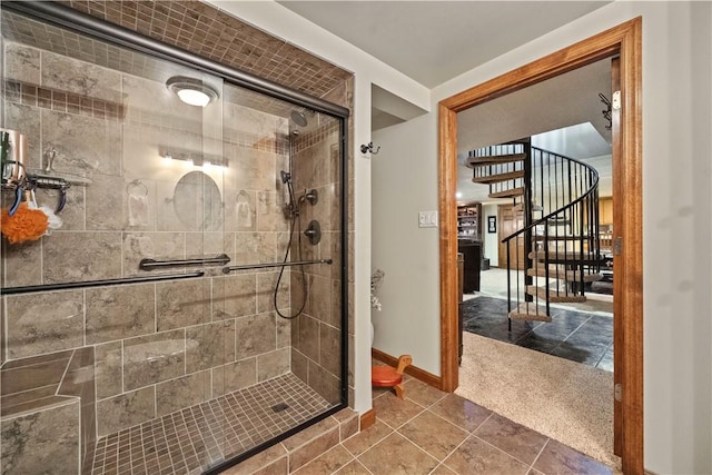 full bath featuring baseboards, tile patterned flooring, and a stall shower