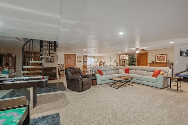 carpeted living area with recessed lighting, ceiling fan, and stairway