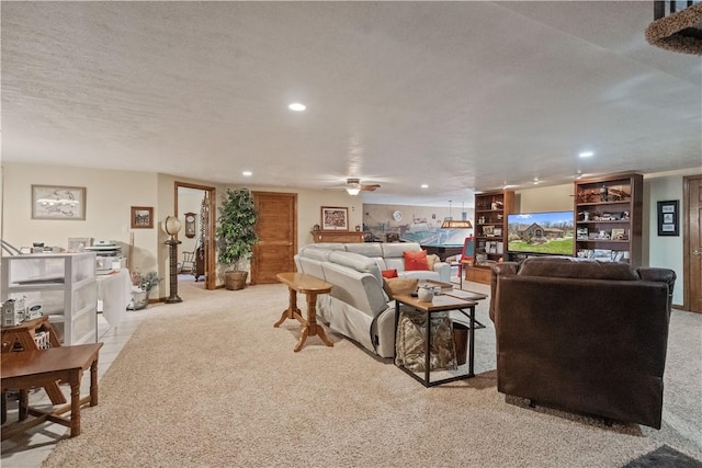living area with carpet floors, ceiling fan, recessed lighting, and a textured ceiling