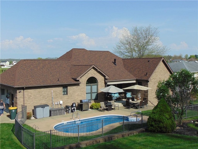 view of swimming pool with fence, grilling area, a fenced in pool, and a patio area