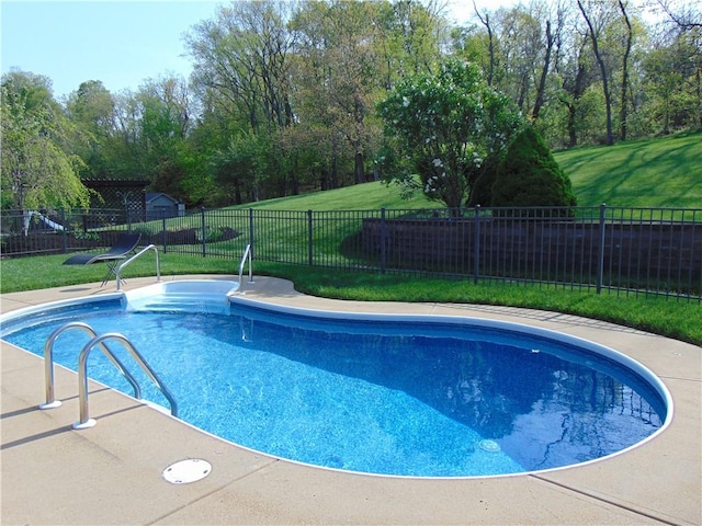 view of pool featuring a fenced in pool, fence, and a yard
