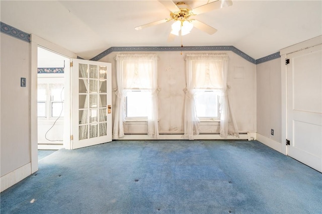 empty room with baseboards, carpet, ceiling fan, and vaulted ceiling