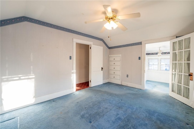 spare room featuring baseboards, a ceiling fan, carpet, and lofted ceiling
