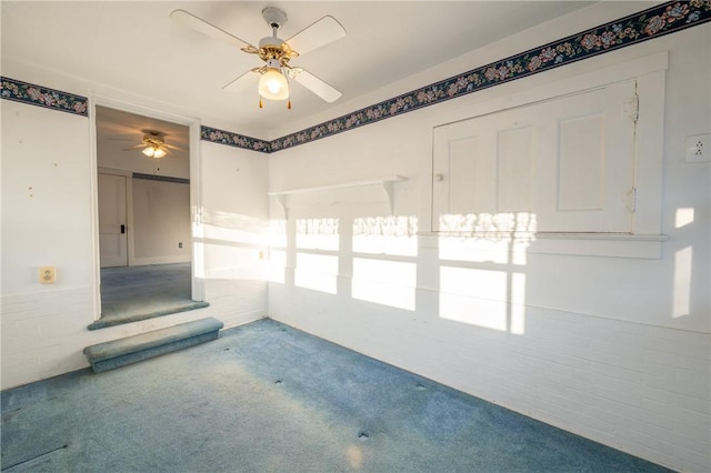 spare room featuring carpet flooring and a ceiling fan