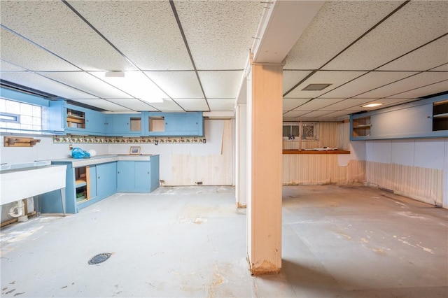 basement featuring a paneled ceiling