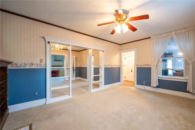 interior space with crown molding, carpet flooring, wallpapered walls, and french doors