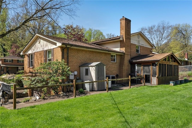 116 Thornberry Dr, Churchill Boro, PA 15235 - rear view of house with a sunroom, a shed, a chimney, and brick siding
