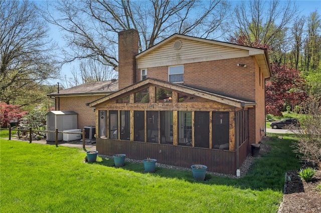 116 Thornberry Dr, Churchill Boro, PA 15235 - rear view of house featuring a sunroom, a chimney, brick siding, and a yard