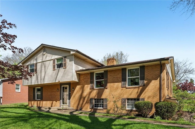 116 Thornberry Dr, Churchill Boro, PA 15235 - split level home with a chimney, a front yard, and brick siding