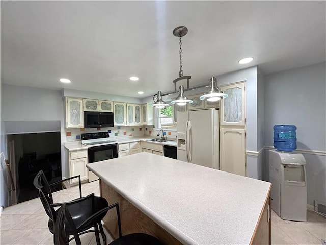 116 Thornberry Dr, Churchill Boro, PA 15235 - kitchen featuring black appliances, light countertops, glass insert cabinets, recessed lighting, and light tile patterned floors