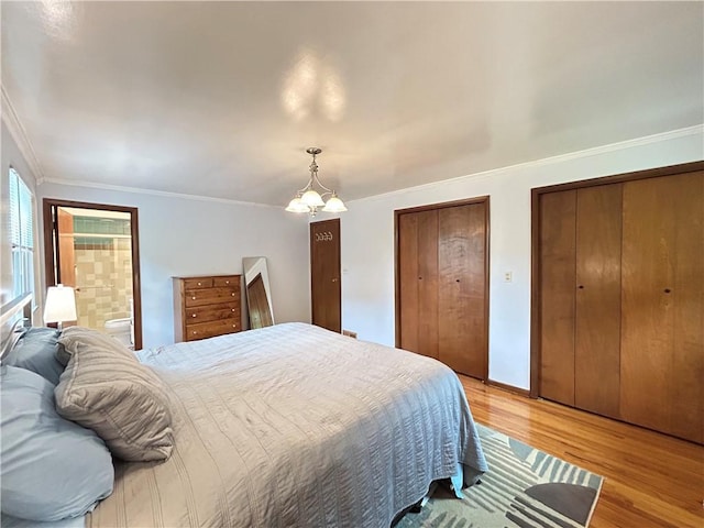 116 Thornberry Dr, Churchill Boro, PA 15235 - bedroom featuring light wood-style flooring, multiple closets, a chandelier, crown molding, and connected bathroom