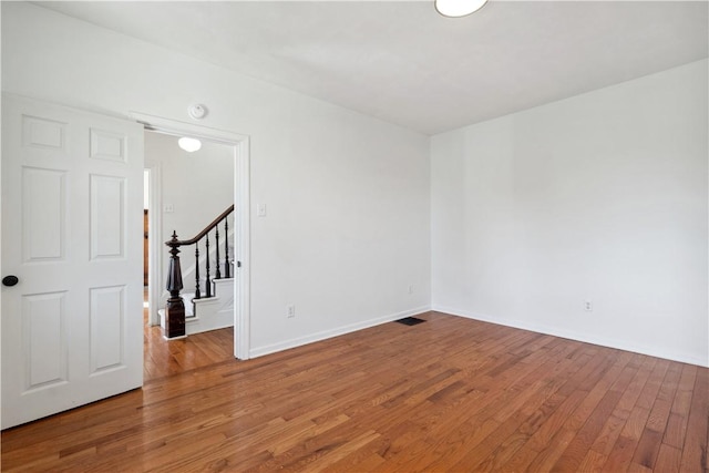 117 Vine St, Belle Vernon Wml, PA 15012 - spare room featuring baseboards, wood finished floors, and stairway