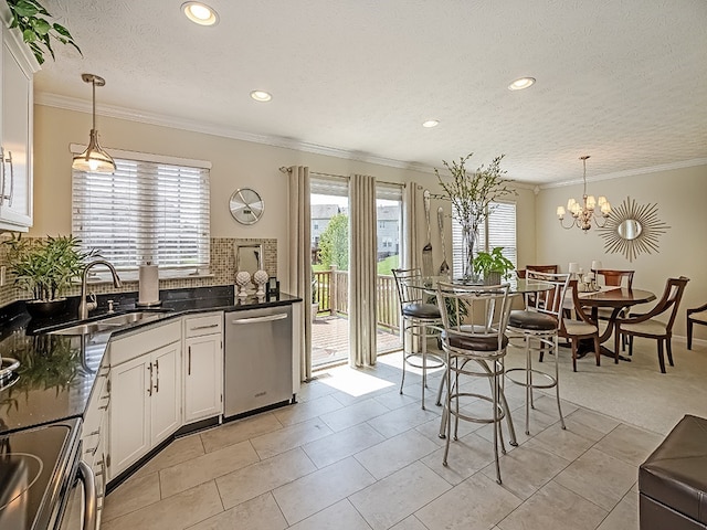 kitchen with a sink, stainless steel dishwasher, recessed lighting, and a wealth of natural light