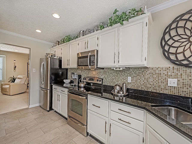 kitchen featuring appliances with stainless steel finishes and white cabinetry