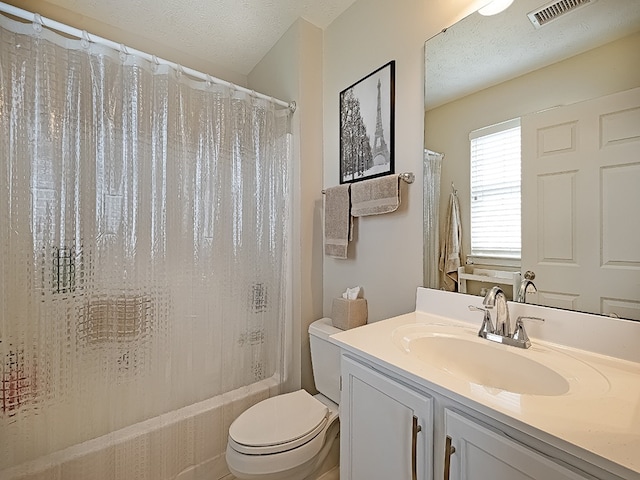 full bathroom with a textured ceiling, visible vents, shower / bath combo, vanity, and toilet