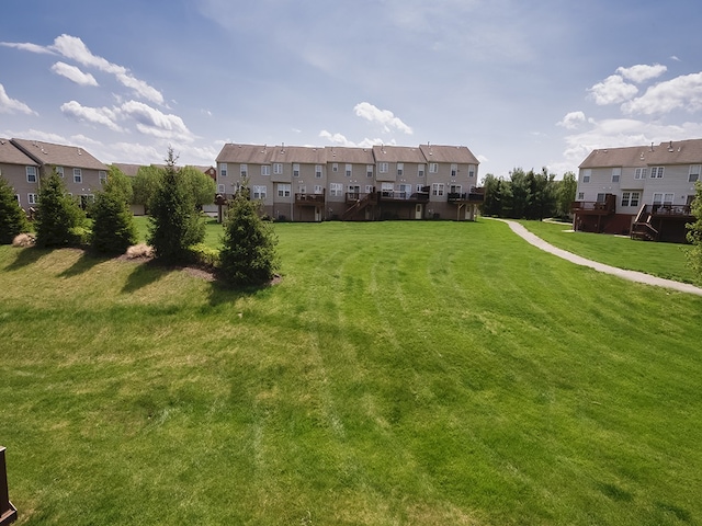 exterior space featuring a lawn and a residential view