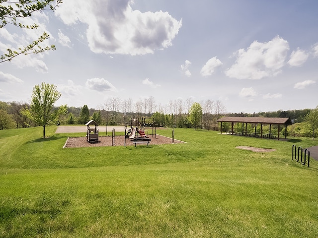 view of property's community with a lawn, a gazebo, and playground community