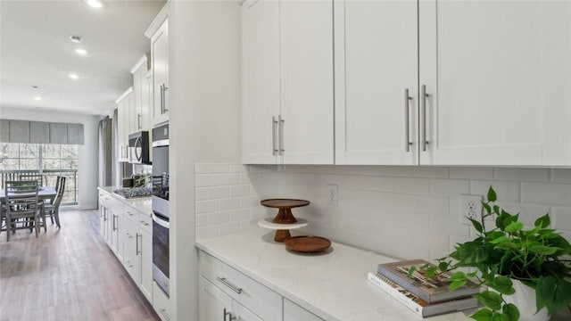 410 Barons Ct, Peters Twp, PA 15367 - kitchen featuring white cabinets, appliances with stainless steel finishes, recessed lighting, and decorative backsplash