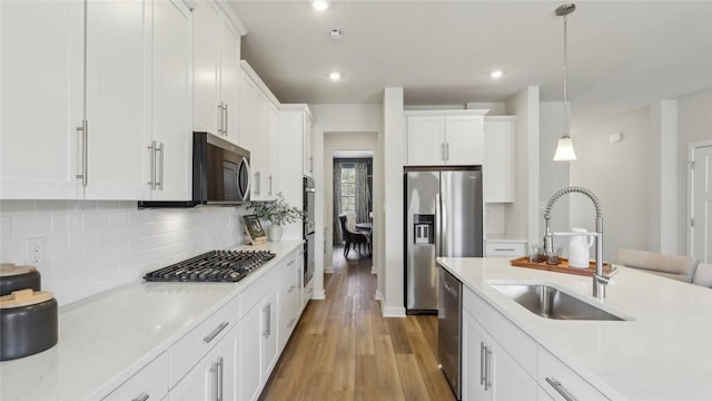 410 Barons Ct, Peters Twp, PA 15367 - kitchen with stainless steel appliances, a sink, light wood-style floors, white cabinetry, and recessed lighting