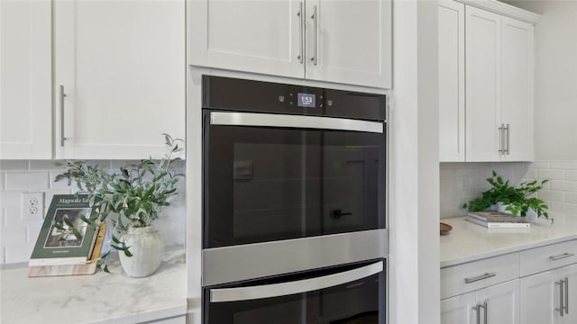 410 Barons Ct, Peters Twp, PA 15367 - kitchen featuring double oven, white cabinetry, and tasteful backsplash