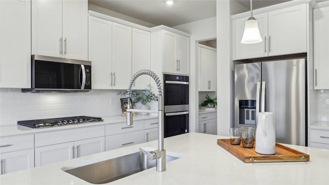 410 Barons Ct, Peters Twp, PA 15367 - kitchen featuring appliances with stainless steel finishes, light countertops, tasteful backsplash, and white cabinetry