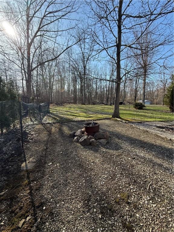 view of yard with a fire pit