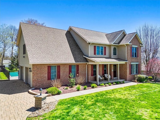 1312 Red Cut Lodge Rd, Derry Twp, PA 15650 - view of front of home featuring a garage, a front lawn, covered porch, brick siding, and driveway