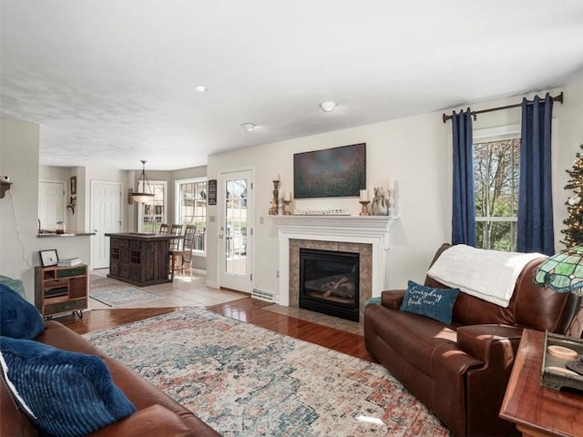 1312 Red Cut Lodge Rd, Derry Twp, PA 15650 - living room featuring a tiled fireplace, wood finished floors, and a wealth of natural light
