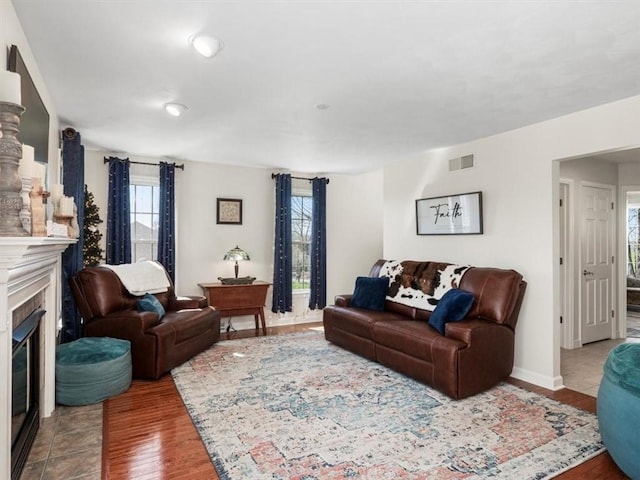 1312 Red Cut Lodge Rd, Derry Twp, PA 15650 - living room with visible vents, baseboards, a glass covered fireplace, and wood finished floors