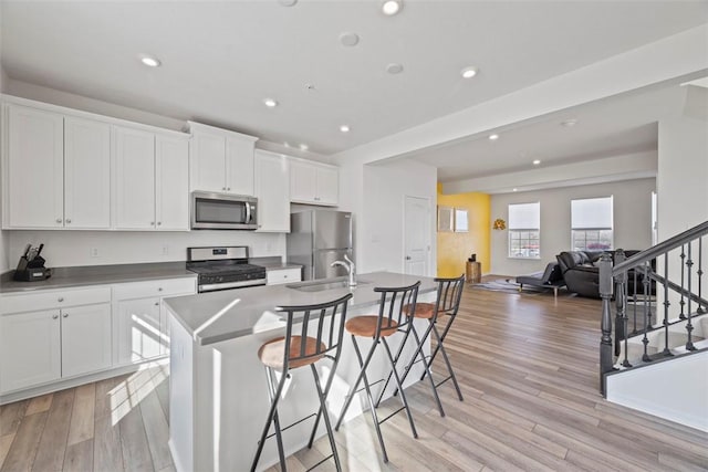 106 Sweetwater Dr, Moon/Crescent Twp, PA 15108 - kitchen featuring white cabinets, a kitchen island with sink, stainless steel appliances, recessed lighting, and light wood-type flooring