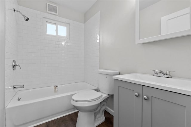 113 Bryant Dr, Penn Hills, PA 15235 - bathroom with vanity, toilet, wood finished floors, shower / bathing tub combination, and visible vents
