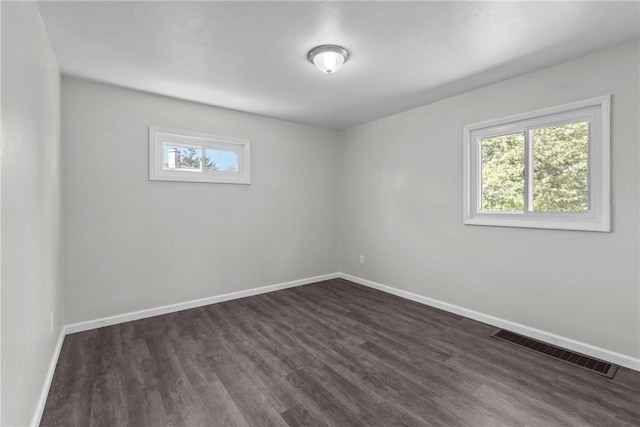113 Bryant Dr, Penn Hills, PA 15235 - spare room featuring dark wood-style flooring, baseboards, visible vents, and plenty of natural light
