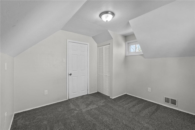 113 Bryant Dr, Penn Hills, PA 15235 - bonus room featuring baseboards, visible vents, dark carpet, and vaulted ceiling