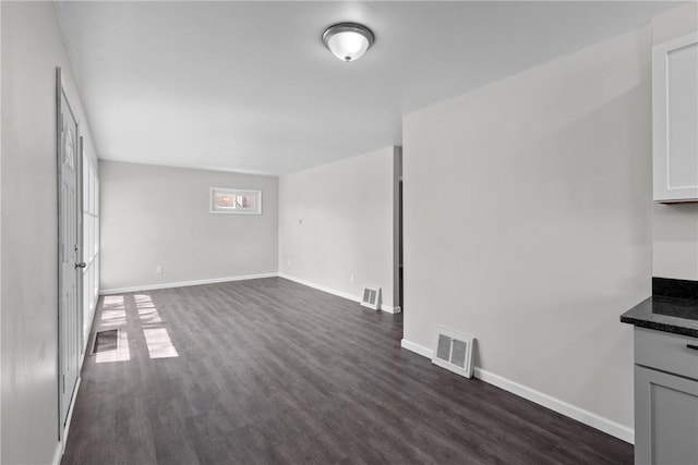113 Bryant Dr, Penn Hills, PA 15235 - unfurnished living room featuring baseboards, visible vents, and dark wood-style floors