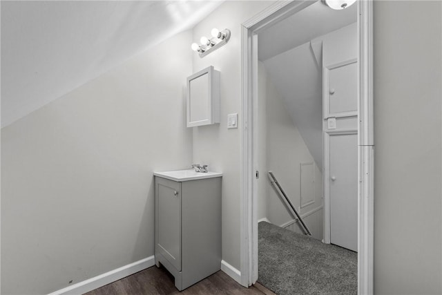 113 Bryant Dr, Penn Hills, PA 15235 - bathroom with baseboards, wood finished floors, vaulted ceiling, and vanity