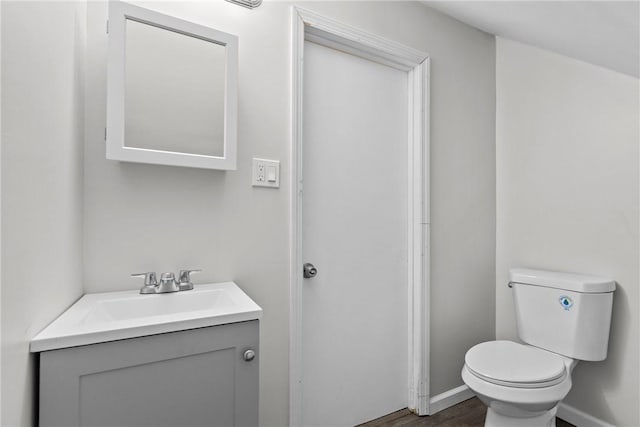 113 Bryant Dr, Penn Hills, PA 15235 - half bath featuring vanity, baseboards, toilet, and wood finished floors