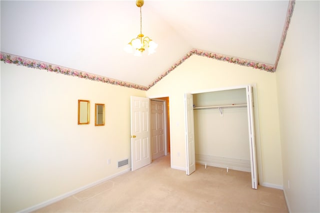 unfurnished bedroom with light carpet, visible vents, baseboards, vaulted ceiling, and a closet