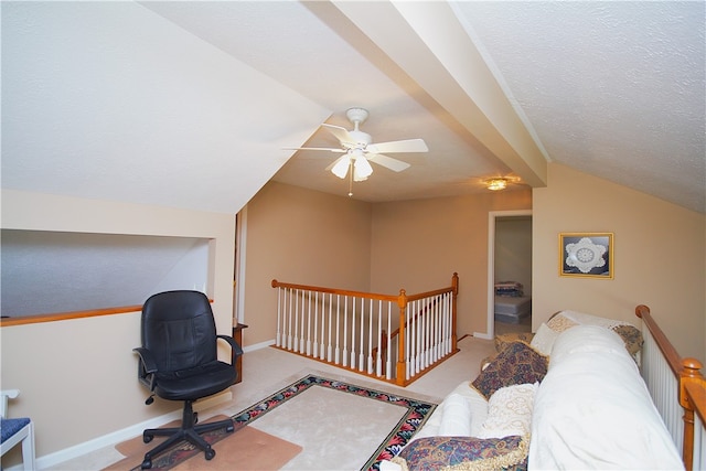 carpeted home office with baseboards, a ceiling fan, a textured ceiling, and vaulted ceiling