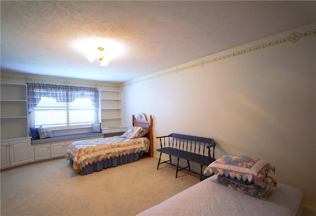 bedroom with a textured ceiling and light colored carpet
