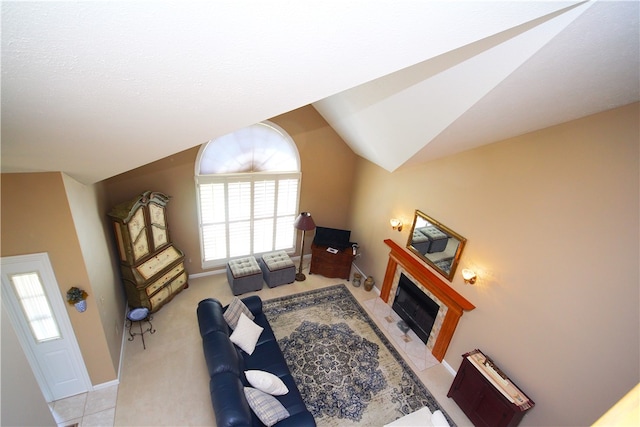 living room with baseboards, a fireplace, and lofted ceiling
