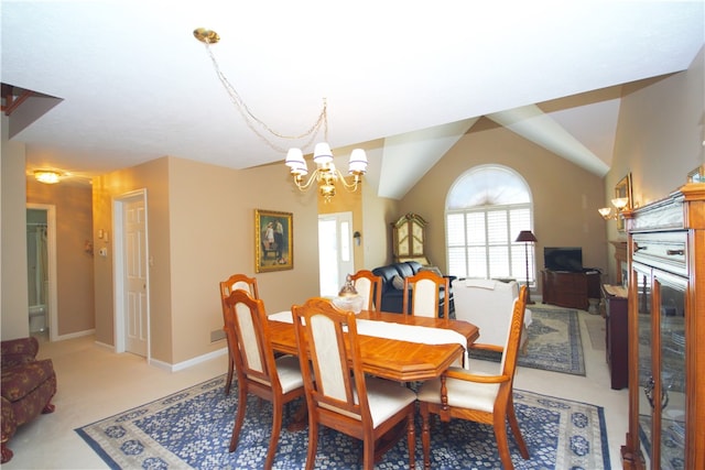 dining room with lofted ceiling, light colored carpet, and a notable chandelier