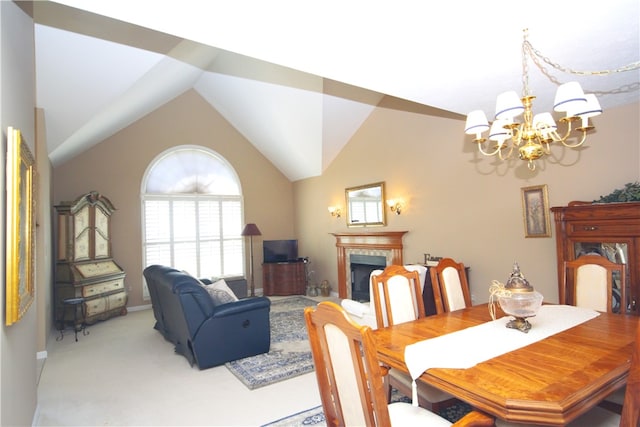 dining area with light colored carpet, an inviting chandelier, a fireplace, baseboards, and vaulted ceiling