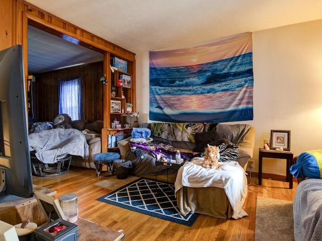bedroom with wood walls and wood finished floors