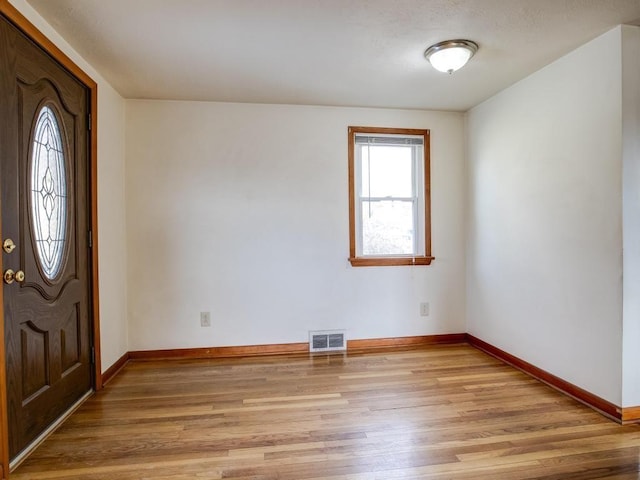 entrance foyer with visible vents, light wood-style flooring, and baseboards